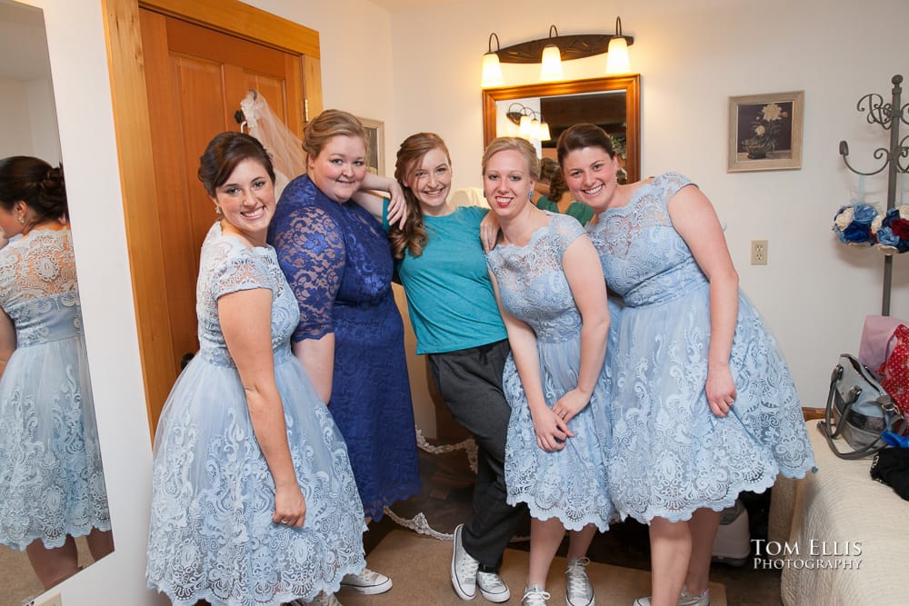 Bride and bridesmaid in the dressing room strike a pose for the camera
