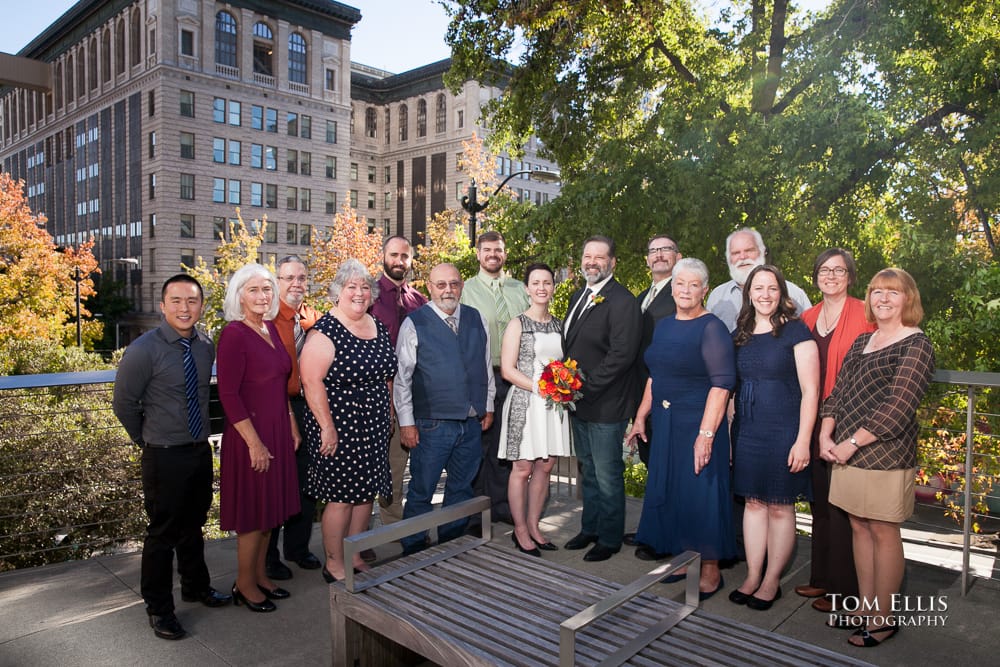 Bride, groom and their family and friends pose for a photo before their elopement wedding at the Seattle Municipal Courthouse