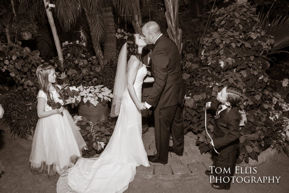 Bride and groom kiss at the conclusion of their wedding ceremony at the Seymour Conservatory in Wright Park