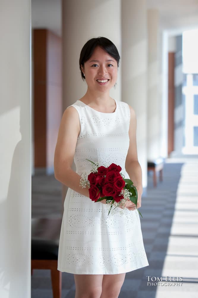 Bride standing in the lobby area before her Seattle Courthouse wedding